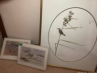 Overall view of five framed prints: one large round-branched bird print, two smaller plaque prints with birds, and one large framed bird print with branches and apples.
