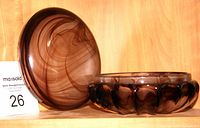 Photo of the deep violet covered bowl and matching lid with swirling smoky patterns, displayed on a wooden shelf.