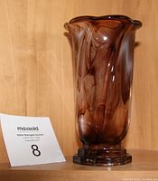 Full view of small fluted violet glass vase showing height, shape and base details