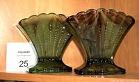 Pair of green and purple cloud glass vases on wooden shelf with auction tag visible