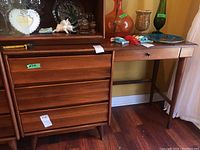 Full view of the Vilas wood desk showing three side drawers and one drawer above the seating area. Various items placed on top but not included in the lot.