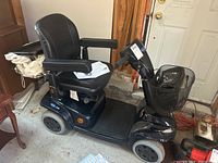 Side view of Invacare Leo mobility scooter on concrete floor without rear basket