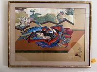 Framed Japanese-style artwork depicting two women in kimono before gold decorative screen