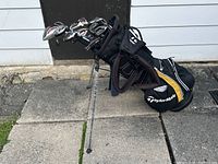 Full view of golf clubs arranged in TaylorMade stand bag with legs extended