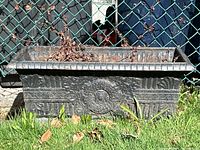 Front view of planter showing central medallion and scroll band.