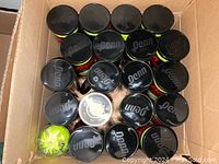 Box showing 20 sealed packs of Penn tennis balls, each pack containing 3 balls, total 60 balls.