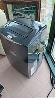 Side view of black LG portable air conditioner unit with visible power cord.