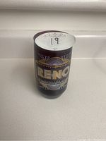 Front side of the glass showing 'RENO' text with sunburst and decorative design