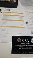 GRA certificate and loose moissanite gemstone together