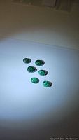 Six smaller polished Malachite cabochon stones with green bands in 1st photo