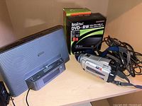 Photo showing Sony Digital Handycam, box of RetailPlus DVD+RW discs, Sony personal audio system speaker, and camcorder carrying case.