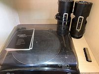 ION Profile LP turntable with closed clear dust cover, showing external condition