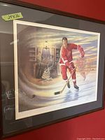 Framed limited edition print showing Gordie Howe skating in Detroit Red Wings red uniform, with a window scene in the background.