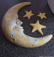 Photo of the full set of ceramic moon and three star wall decorations showing size and shape