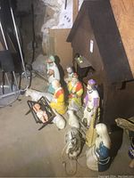 Full view of assembled nativity set with stable, baby Jesus in manger, shepherd, angel, three wise men, Mary, Joseph, cow, and sheep figurines.