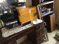 View of Episcopio slide projector in original black and white box with carrying case, Kodak Carousel 140 and Transvue 80 trays stacked beside boxes.