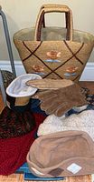 Overview photo showing woven floral tote bag, gloves, earmuffs, and several hats in various colors and fabrics.