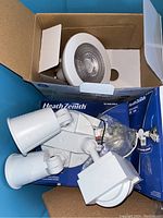 White Heath Zenith motion sensor light fixture with two adjustable heads inside box