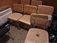 Six cane chairs grouped together