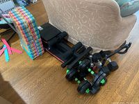 Grouped photo showing folding bench, dumbbells, pull-up bar, and stacked colorful foam mats on wooden floor