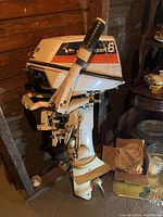 Front-left view showing cover, tiller handle and propeller