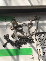 Photo showing assortment of rings, necklaces with pendants, earrings and a decorative bracelet.