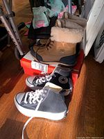 All three pairs stacked together showing UGG boots, Converse sneakers, and Nike shoes