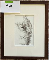 Framed black ink abstract portrait drawing showing the face in profile.