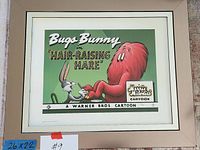 Beige-framed giclee lobby card print titled “Bugs Bunny in Hair-Raising Hare” featuring Bugs Bunny and red monster Gossamer on green background with “Merrie Melodies Cartoon” and “A Warner Bros. Cartoon” text