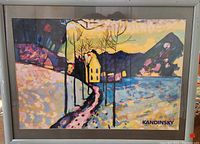 Framed colorful Kandinsky poster titled Hermitage Leningrad showing a landscape with a path, yellow house, trees, water, mountain background.