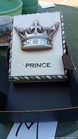 Front view of rectangular Sid Dickens memory block titled 'Prince' with raised silver crown and 'PRINCE' text.