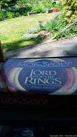 Photo of the Monopoly Lord of the Rings Trilogy Edition board game box with thematic map design on top.