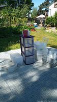 Outdoor photo of Sterilite 3-drawer organizer with multiple clear plastic containers arranged around it on a cloth.