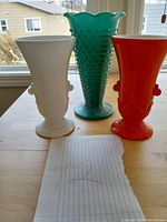 Front view of the 3 vases: white and red Anchor Hocking Vitrock vases and teal Fire King hobnail trumpet vase