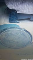 Round cast iron griddle pan showing worn surface and general condition.