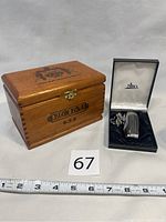 Wooden box and Nibo butane lighter with presentation box shown beside a measuring tape