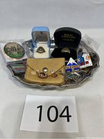 Overview of lot contents displayed on electroplated silver tray, includes rings in boxes, gemstones, buttons