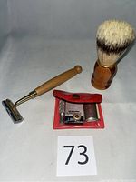 Full lot showing razor, brush, and red case with blades