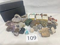 Full display of the rock collection in a group with black boxes in the background