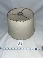 Full view of the lamp shade next to measuring tape showing size and shape.