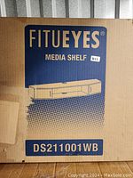 Box showing Fitueyes media shelf with product model number DS211001WB, packaged and unopened.