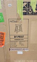 Photo of packaging box label showing brand, model number DF-PR507, Promenade Stool, carton dimensions, weight, and origin Indonesia.