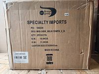 Cardboard shipping carton with label showing product SKU and quantity of 2 stools.