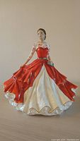 Front view of Royal Doulton Freya B porcelain figurine in red and white gown.