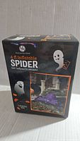 Box packaging showing brand, product image and features: self-inflating spider measuring 4 feet, lights included.