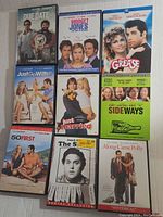 18 assorted DVD cases arranged in two groups showing front covers of various comedy and romantic movies.