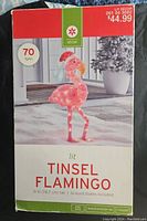 Box packaging showing lit tinsel flamingo decoration, 31 inches tall with 70 lights.
