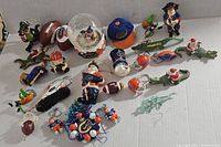 Full overview of the lot showing Florida Gator Christmas ornaments including alligator figurines, football ornaments, snow globe, and cap.