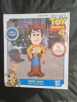 Box front showing Toy Story 4 Woody inflatable figure artwork, indicating 3.5 feet tall size and new in box condition.