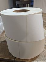 Two stacked rolls of blank white rectangular direct thermal labels each measuring 4x6 inches.